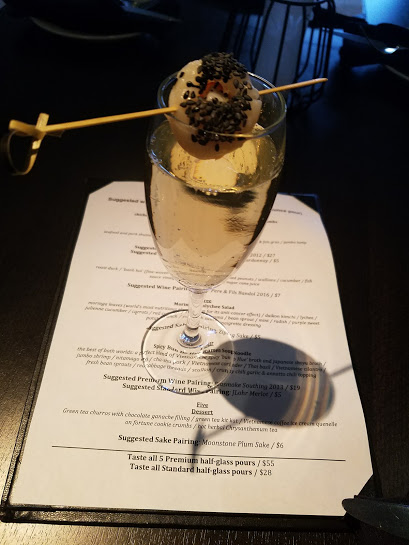 A glass of wine on top of a menu.