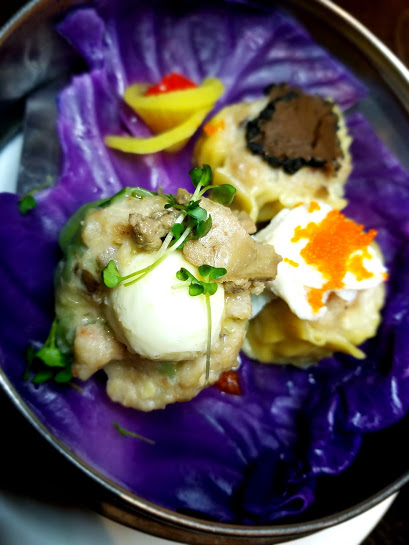 A plate of food with an egg and some other things.