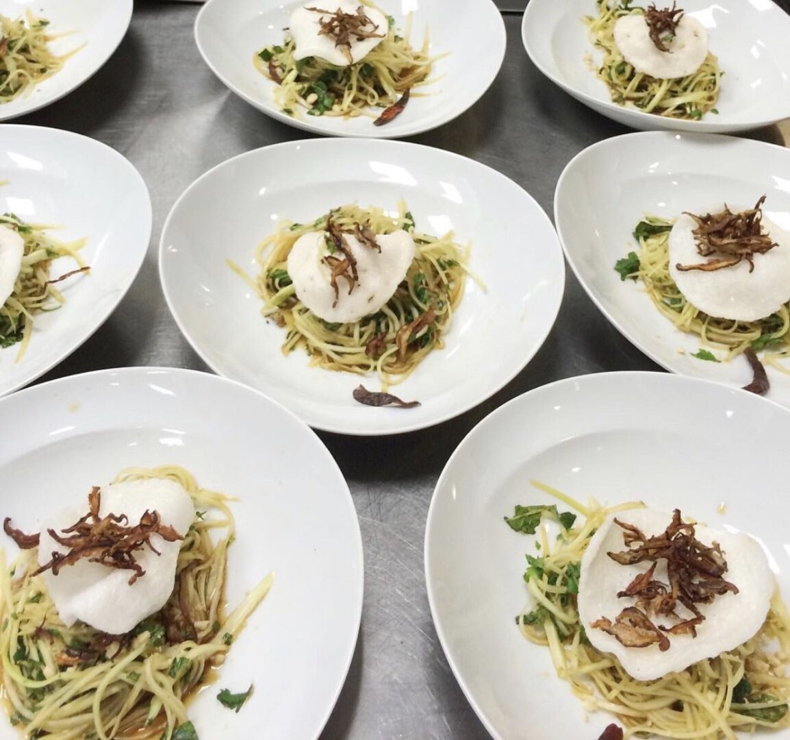 A bunch of plates that are on top of some food.