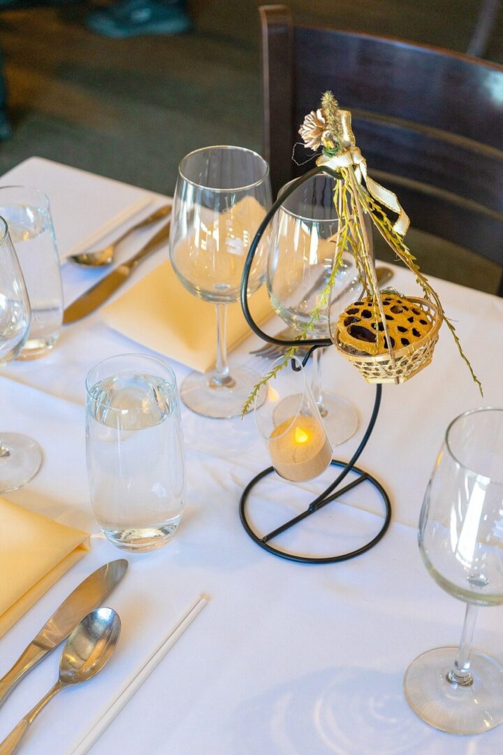 A table set with glasses and silverware on it.