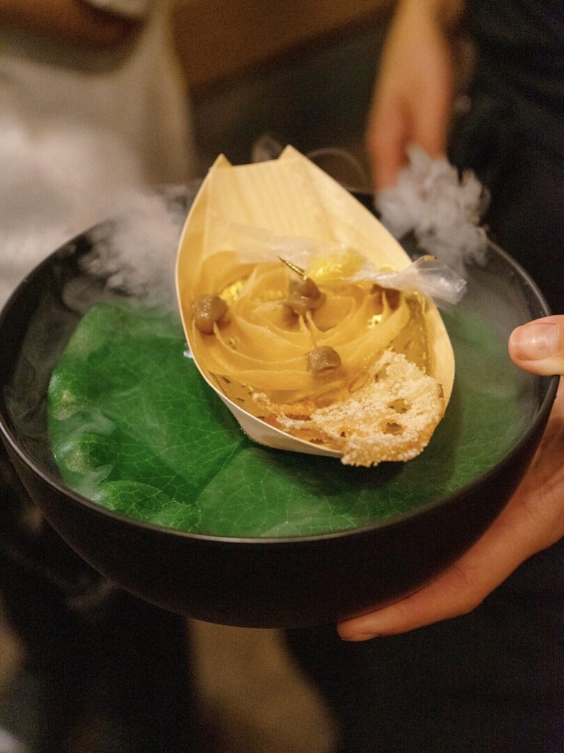 A person holding a plate with food on it.