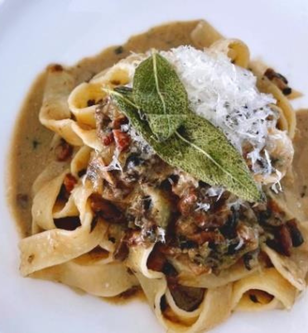 A plate of pasta with meat and sauce.