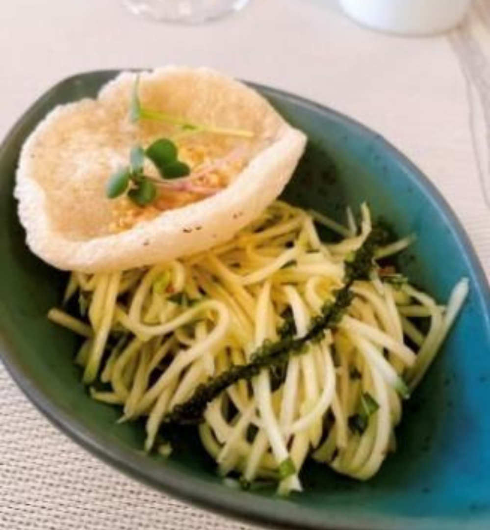 A plate of food with some noodles and vegetables